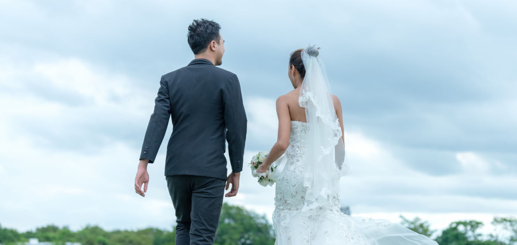 Young happy couple on their wedding day, registering their marriage via Our Marriage Journey